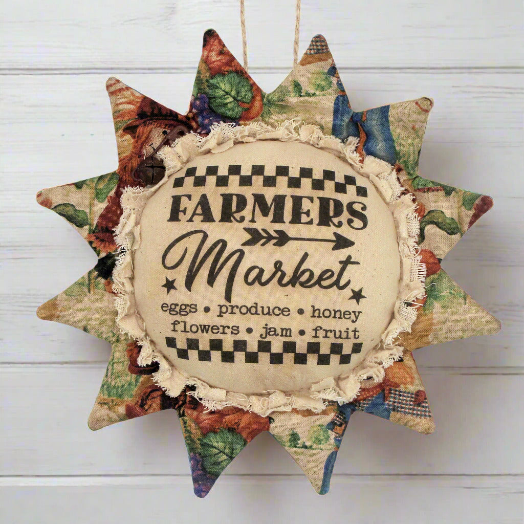 Primitive fabric sunflower ornament with an advertisement for a farmers market