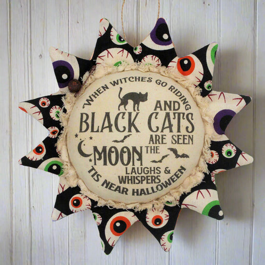 Primitive fabric sunflower ornament with a Halloween poem printed on its center