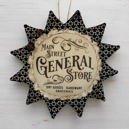 Primitive fabric sunflower ornament with an advertisement for the Main Street General Store