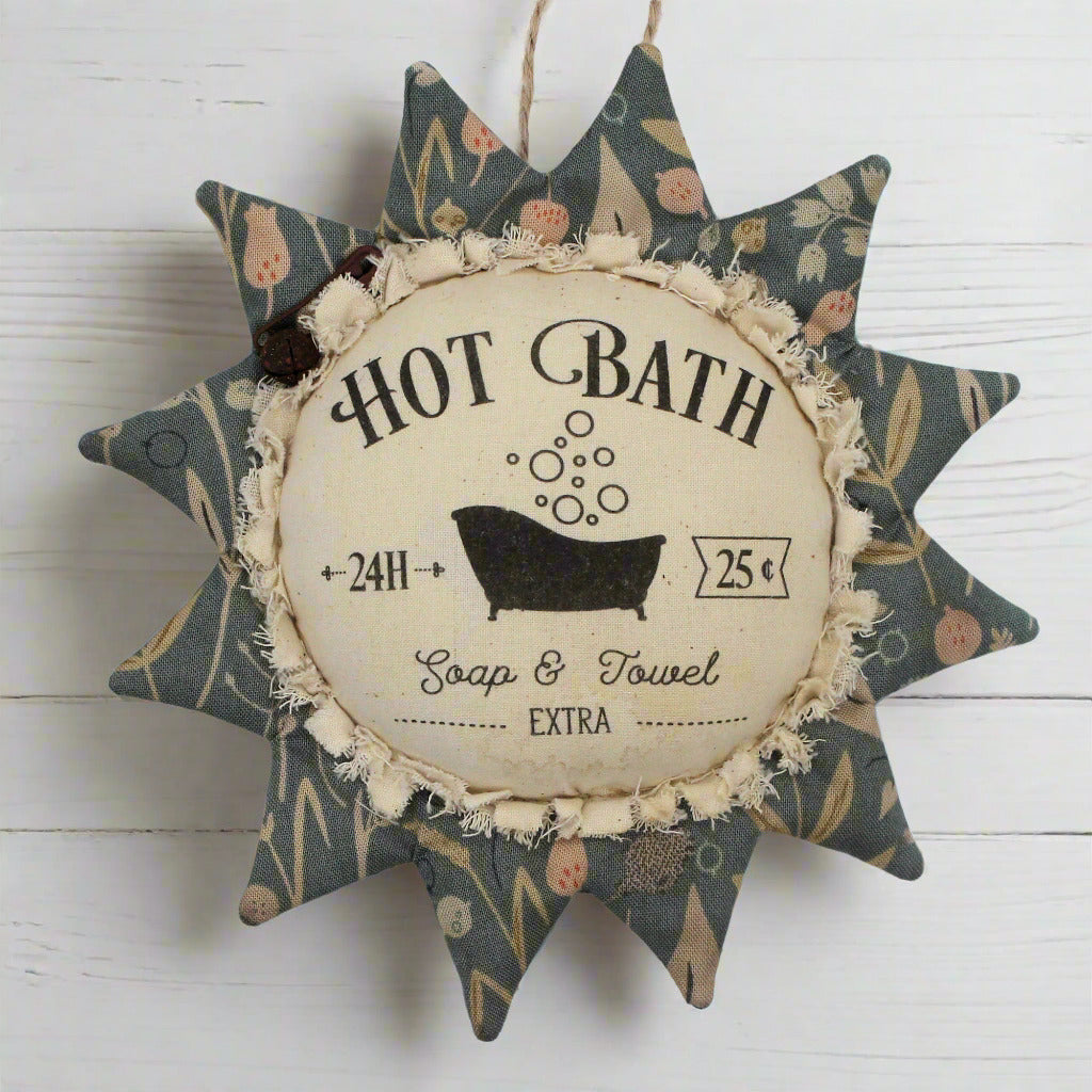 Primitive fabric sunflower ornament with an advertisement for a hot bath