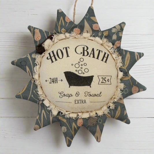 Primitive fabric sunflower ornament with an advertisement for a hot bath