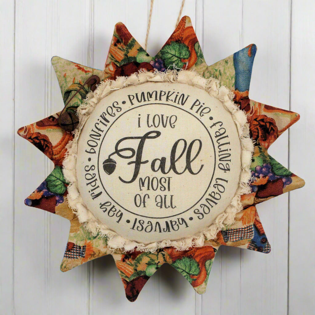Primitive sunflower ornament with the text 'I love fall most of all'