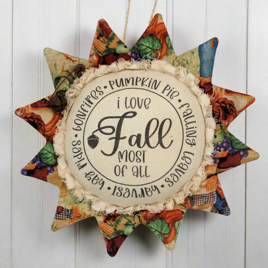 Primitive sunflower ornament with the text 'I love fall most of all'