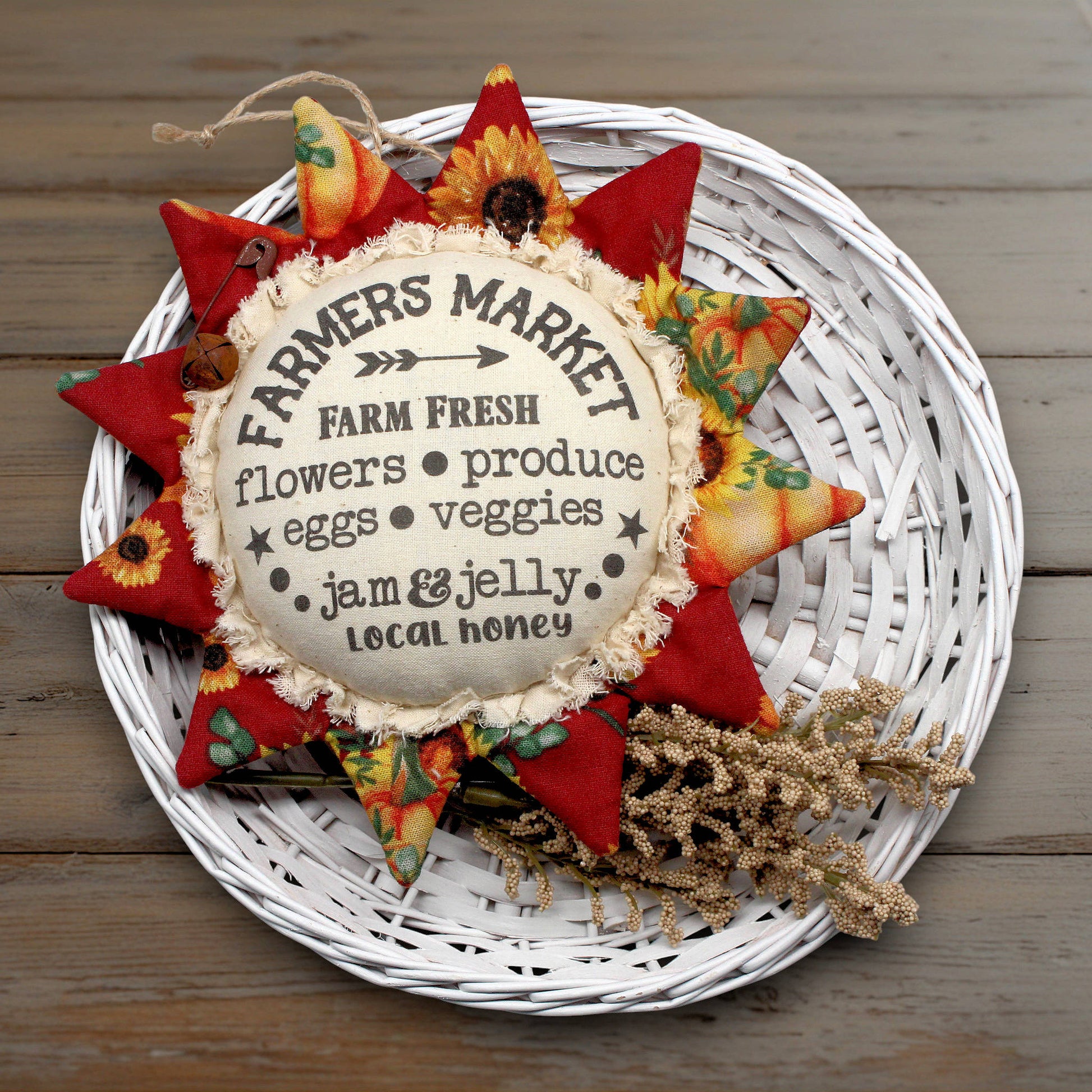 Primitive fabric sunflower ornament with an advertisement for a farmers market