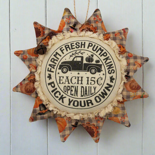Primitive fabric sunflower ornament with an advertisement for farm fresh pumpkins
