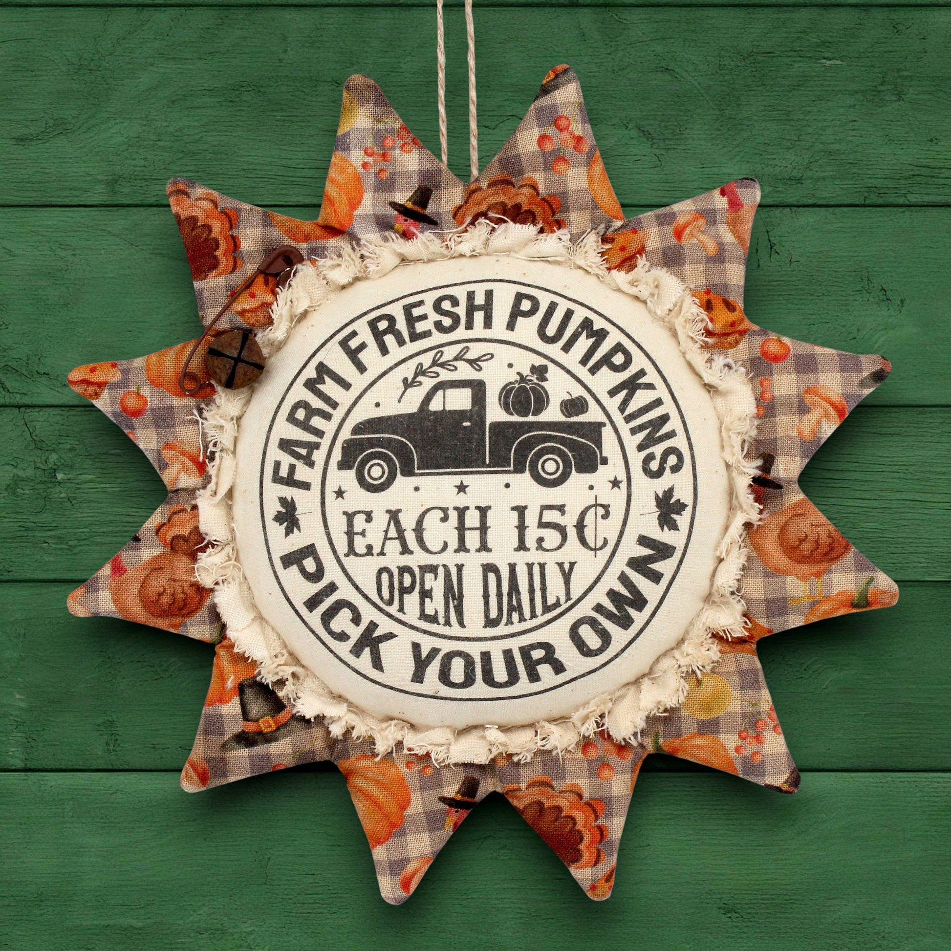 Primitive fabric sunflower ornament with an advertisement for farm fresh pumpkins