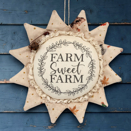 Decorative fabric sunflower sign with 'Farm Sweet Farm' text on a white background