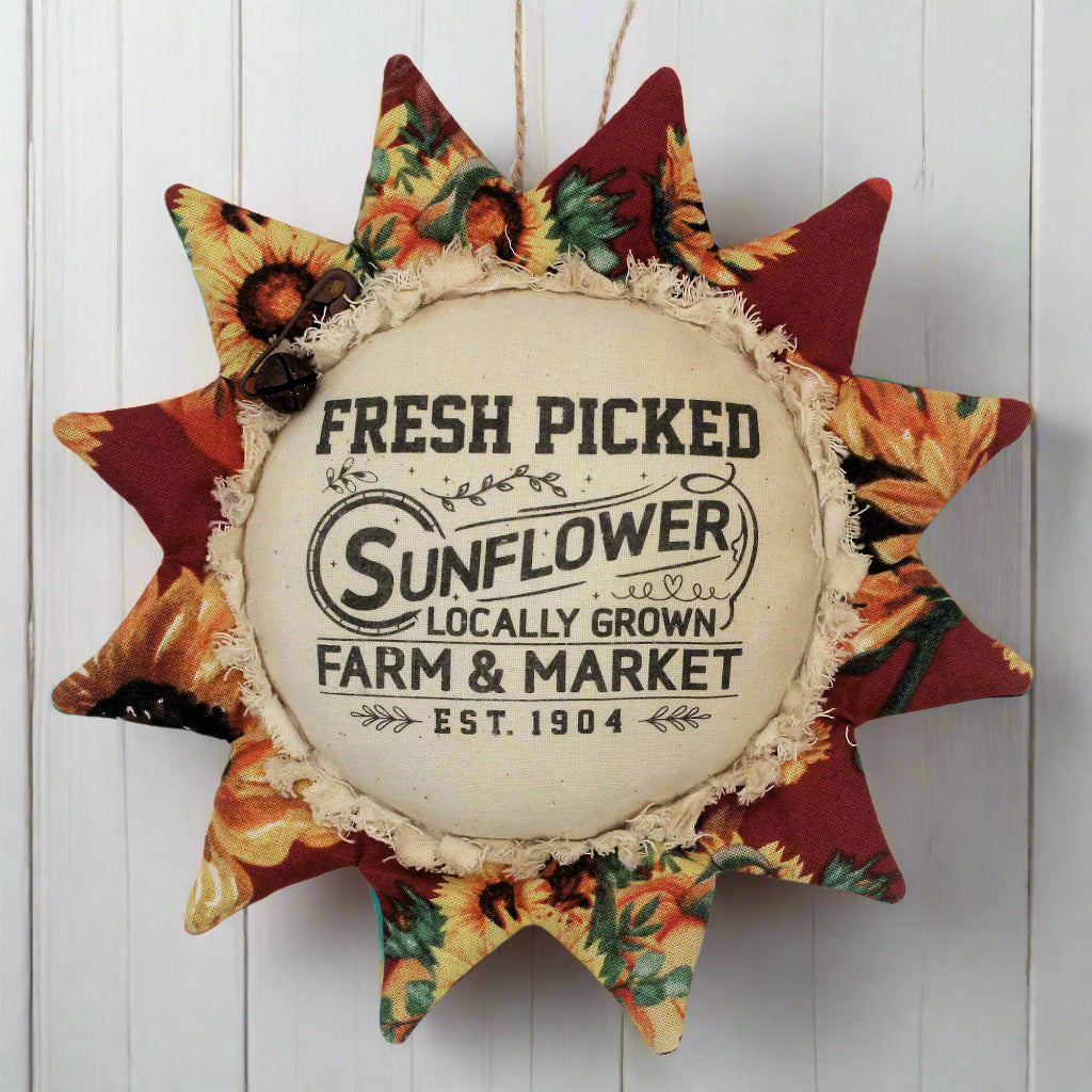 Primitive fabric sunflower ornament with an advertisement for a farm market