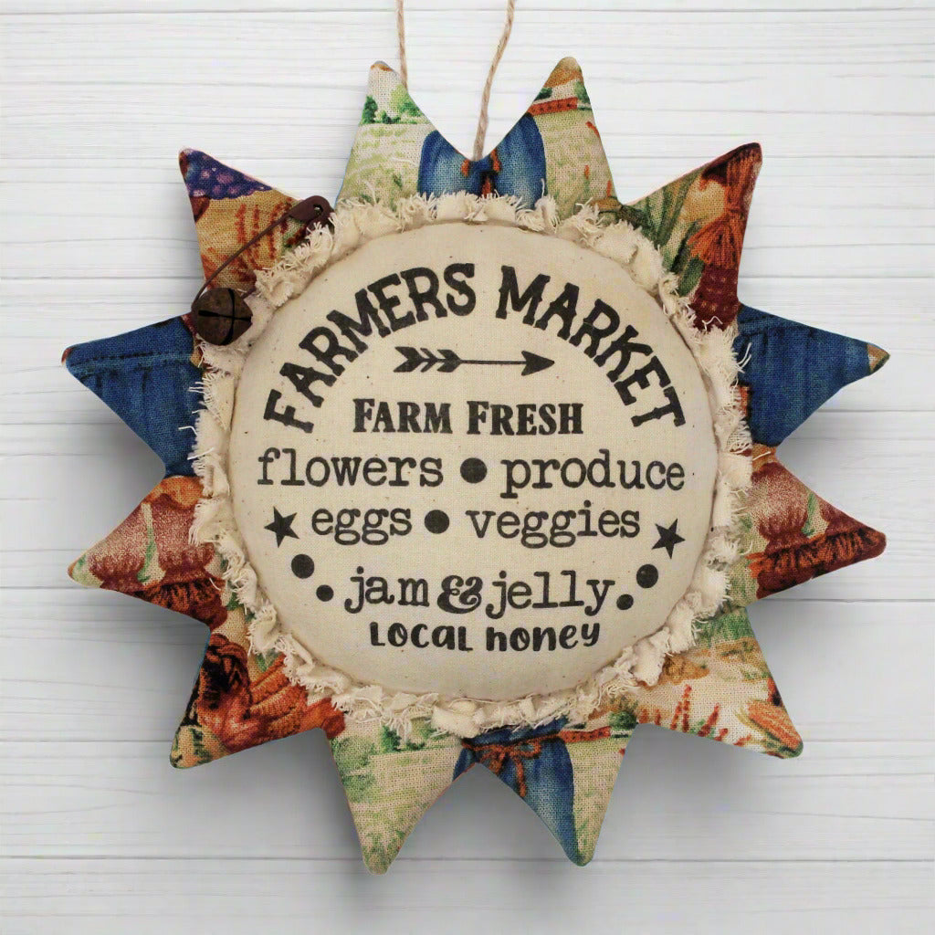 Primitive fabric sunflower ornament with an advertisement for a farmers market
