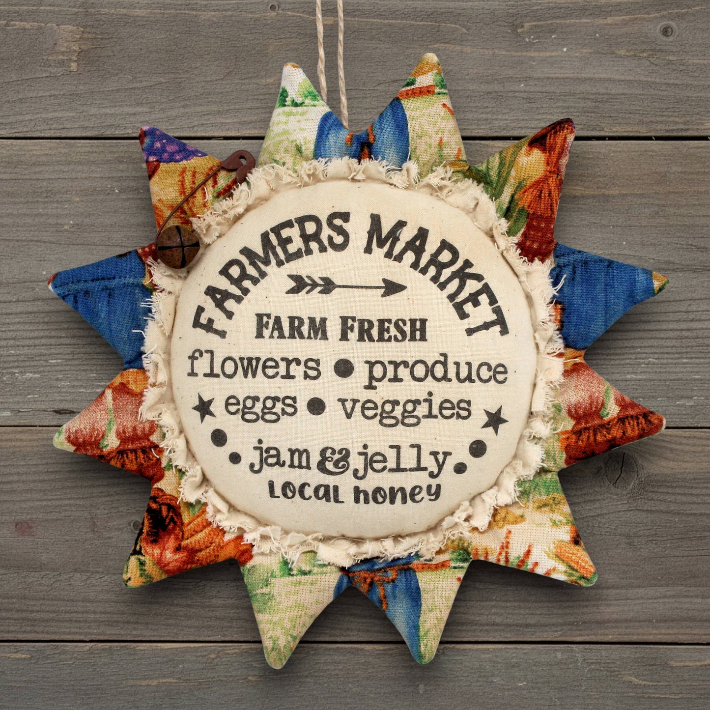 Primitive fabric sunflower ornament with an advertisement for a farmers market