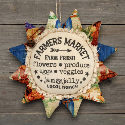 Primitive fabric sunflower ornament with an advertisement for a farmers market