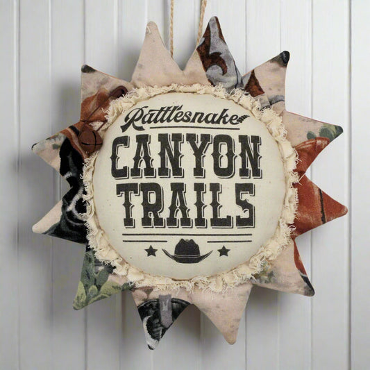 Western style fabric sunflower ornament with an advertisement for Canyon Trails