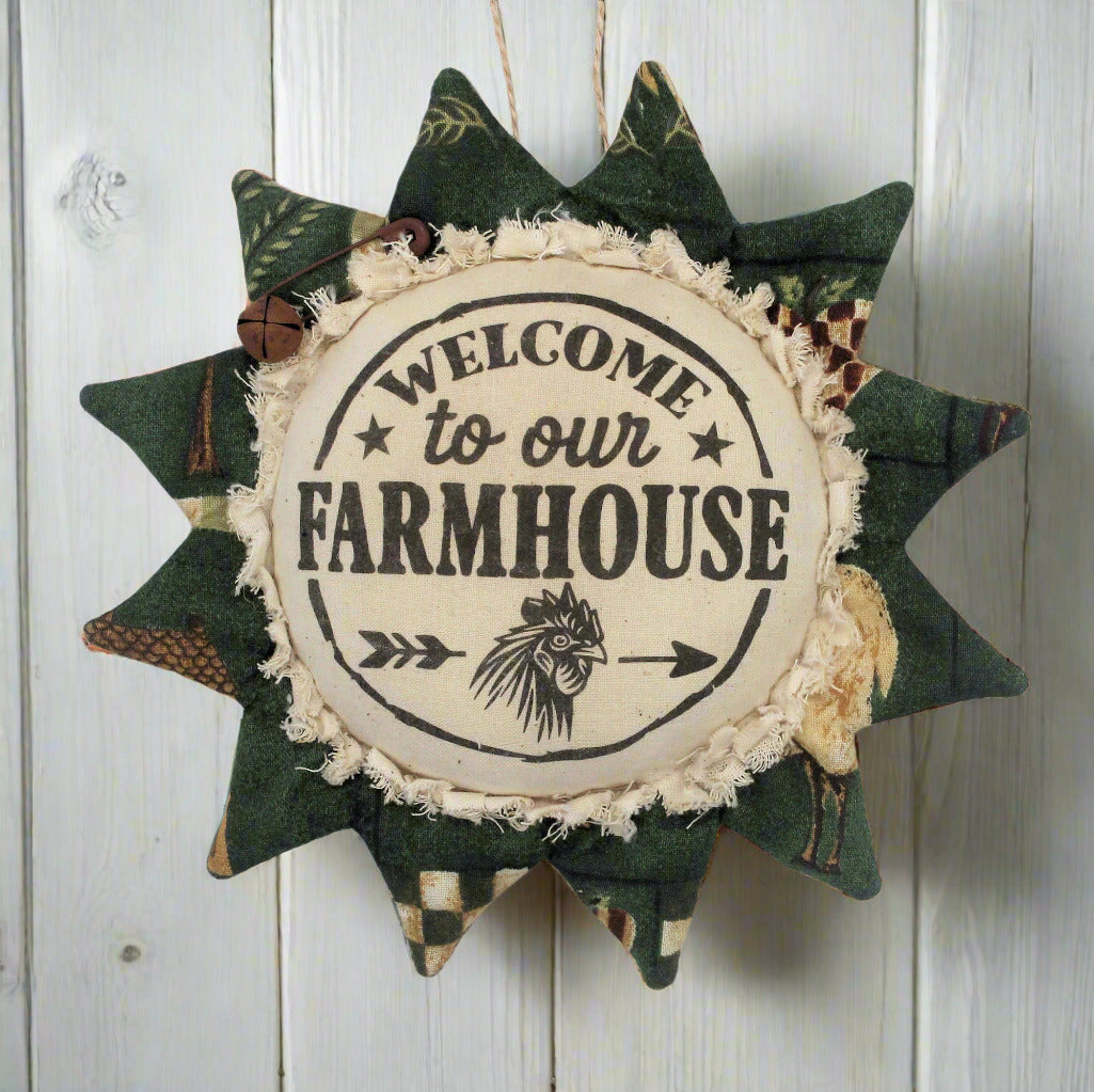 Decorative sunflower ornament with 'Welcome to our Farmhouse' text on a wooden background