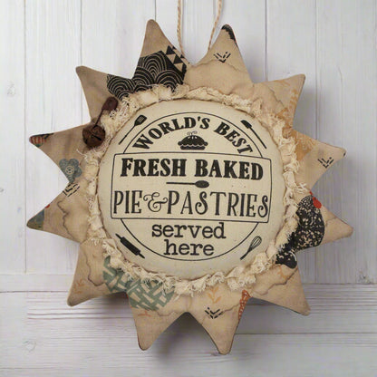 Primitive sunflower ornament with an advertisement for pies and pastries