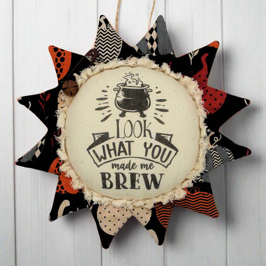 Primitive fabric sunflower ornament with a witches brew text