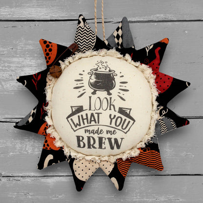 Primitive fabric sunflower ornament with a witches brew text
