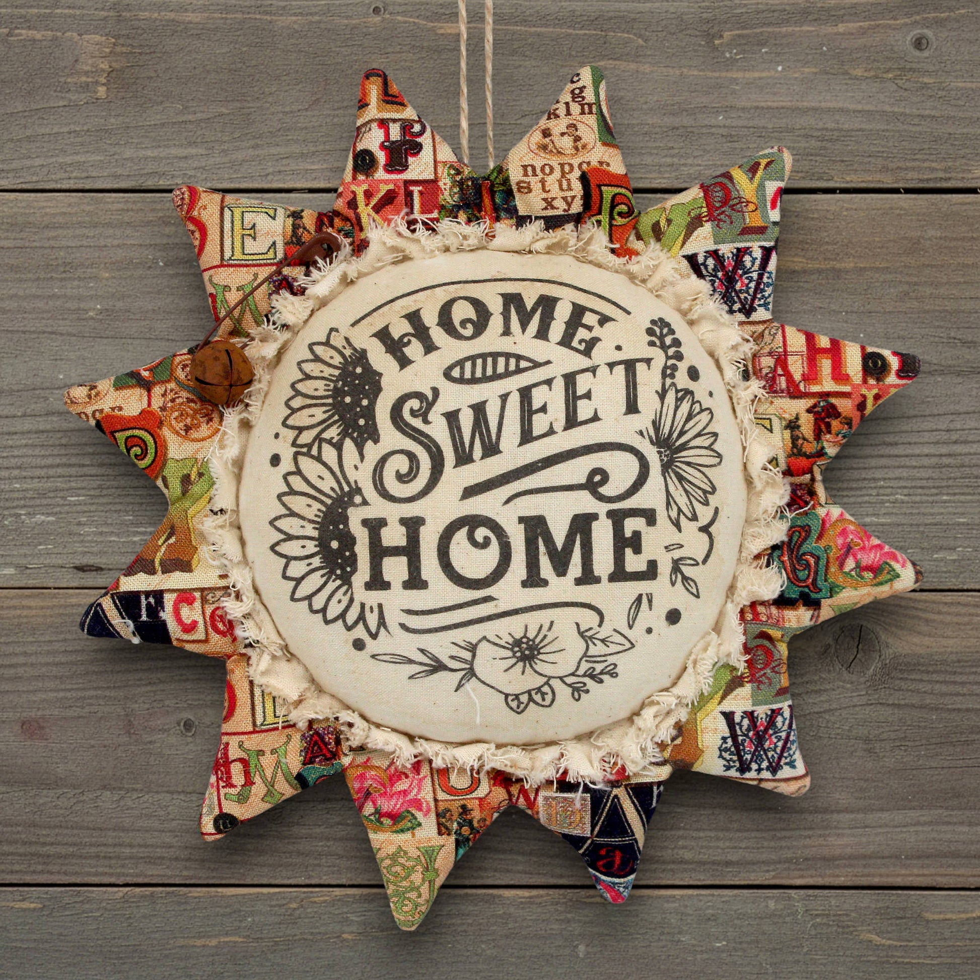 Primitive fabric sunflower ornament with Home Sweet Home printed on its center