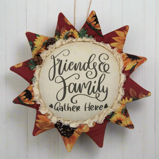 Primitive sunflower ornament with 'Friends & Family Gather Here' text on a white background