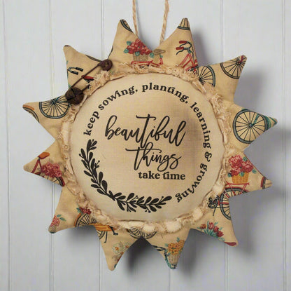 Primitive sunflower ornament with the motivational quote 'Beautiful things take time'