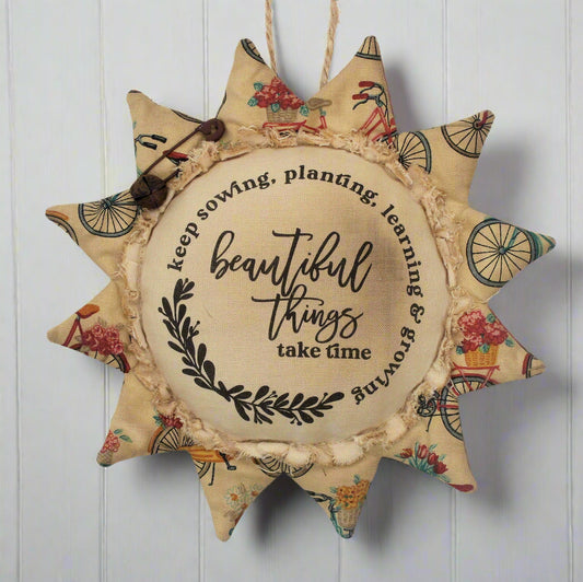 Primitive sunflower ornament with the motivational quote 'Beautiful things take time'