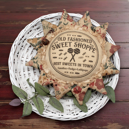 Primitive sunflower ornament with an advertisement for an old fashioned sweets shop