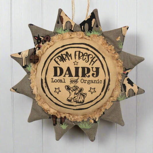 Primitive sunflower ornament with an advertisement for a farm fresh dairy