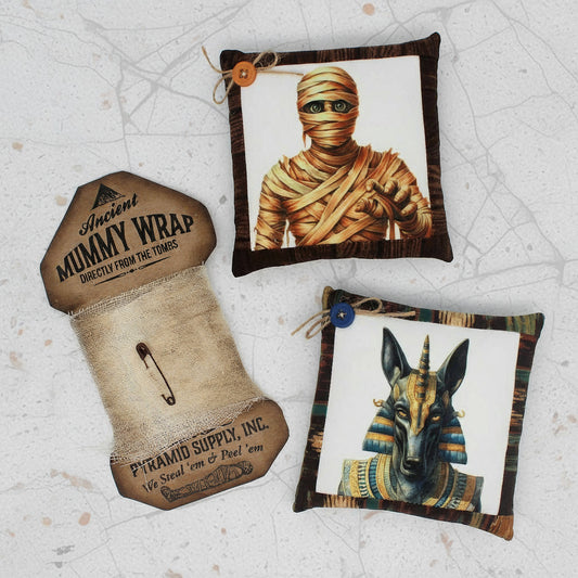 Decorative pillows with mummy and Egyptian god design on a white background