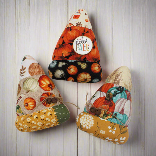 Set of three colorful candy corn bowl fillers in fall-themed fabrics