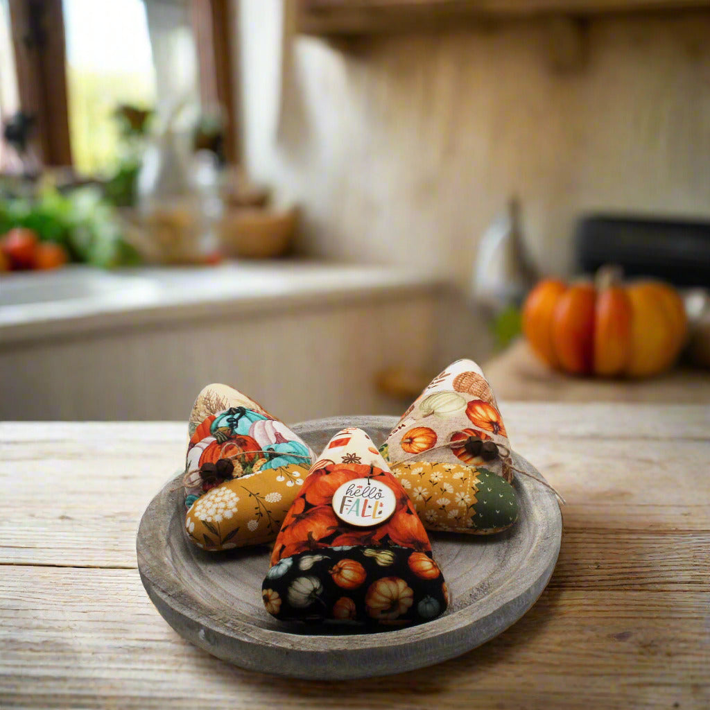 Set of three candy corn bowl fillers in autumn-themed fabrics