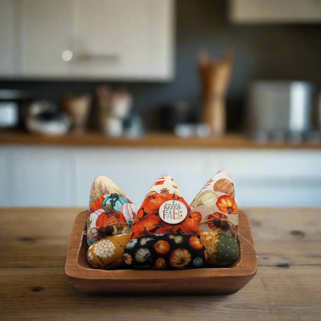 Set of three candy corn bowl fillers in autumn-themed fabrics