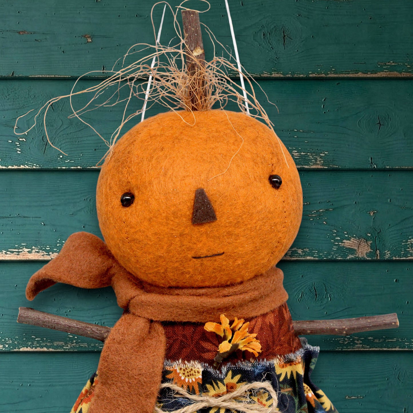 Pumpkin character doll in a sunflower skirt
