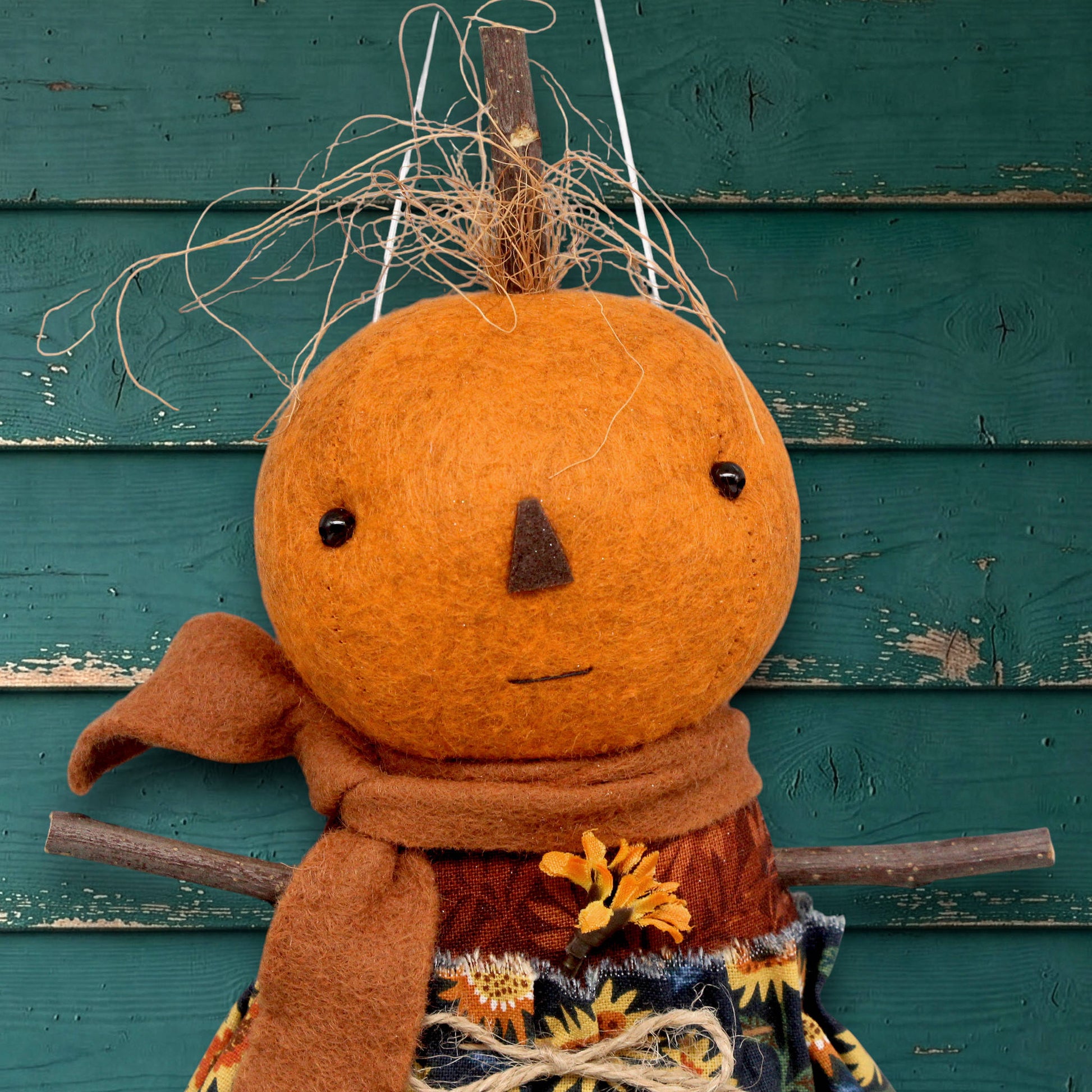 Pumpkin character doll in a sunflower skirt