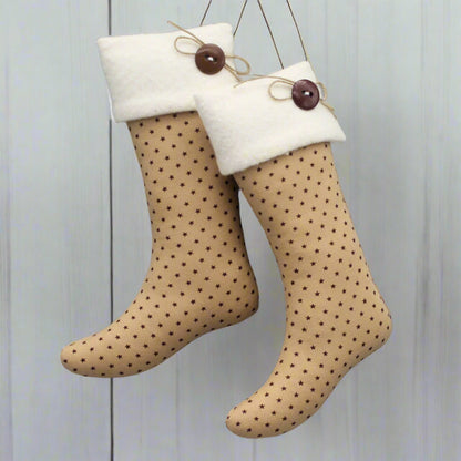 pair of Christmas stocking ornaments with tiny burgundy stars on a tan background with white fleece cuffs