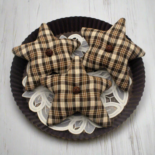  Three homespun star bowl fillers with buttons on a decorative tray.