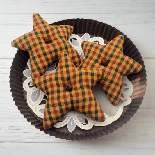 Plaid star-shaped objects on a decorative plate with a white background