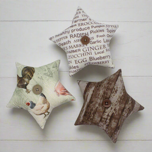 Three star bowl fillers with fabric designs on a white wooden surface
