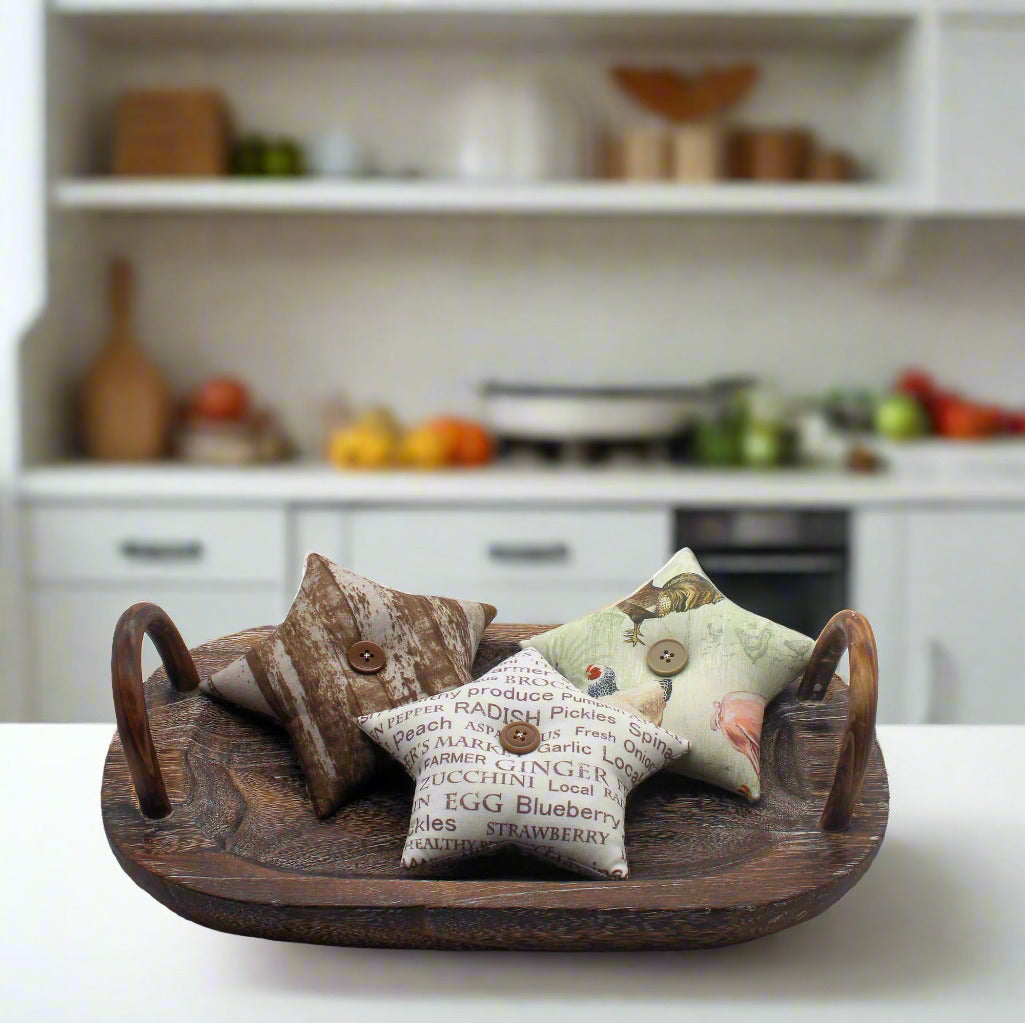 Decorative star bowl fillers on a wooden tray with a kitchen background