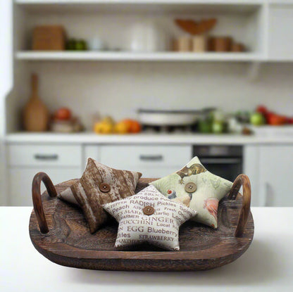 Decorative star bowl fillers on a wooden tray with a kitchen background