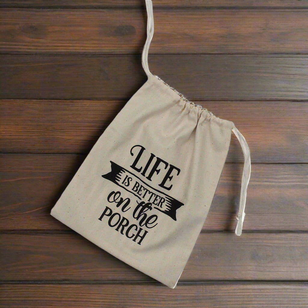 Muslin drawstring bag with 'Life is better on the porch' text