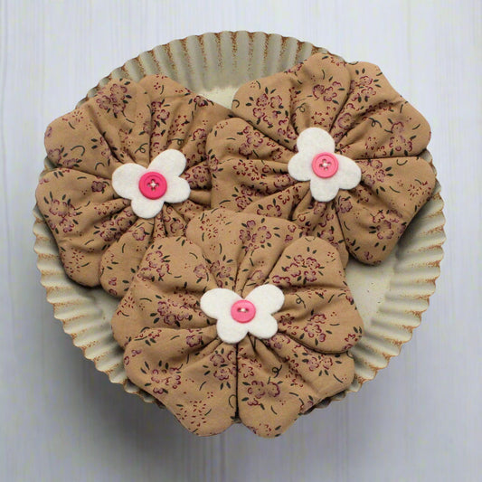 Flower bowl fillers with floral patterns and white flowers with pink centers on a white background