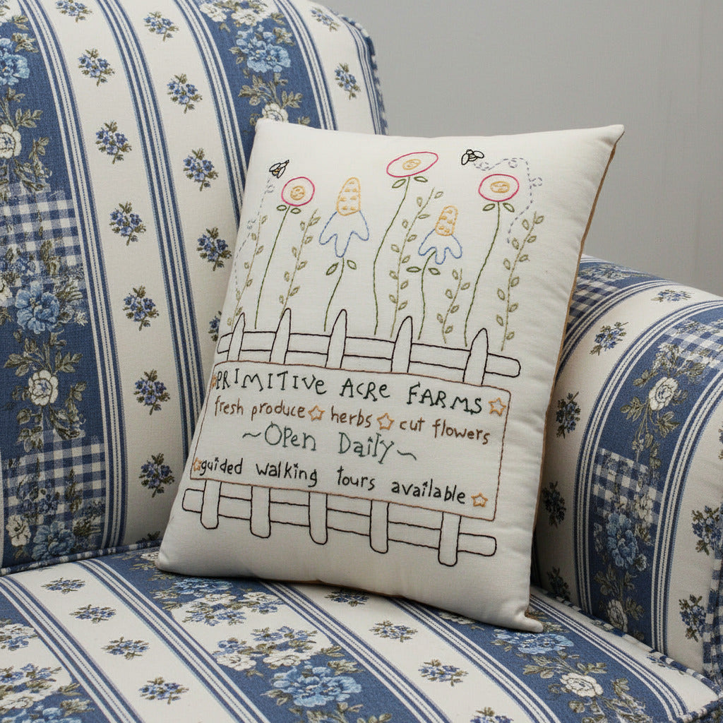 Hand-stitched decorative pillow with a primitive flower farm design