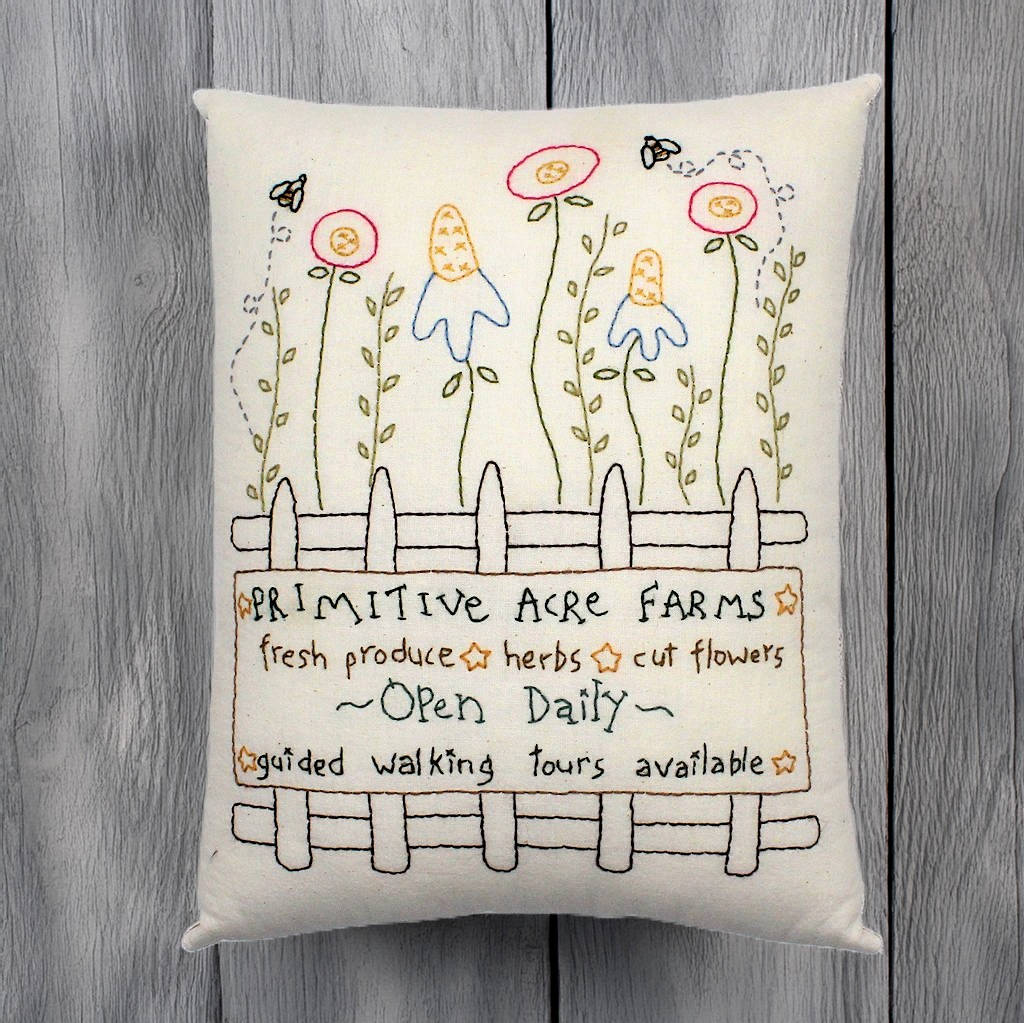Hand-stitched decorative pillow with a flower garden design