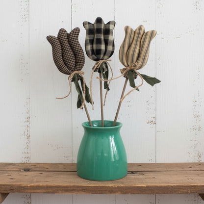Three fabric tulips in a green vase on a white background