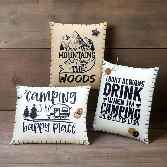 Three decorative mini pillows with camping-themed sayings