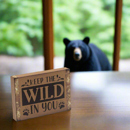 Wooden sign with 'Keep the Wild in You'