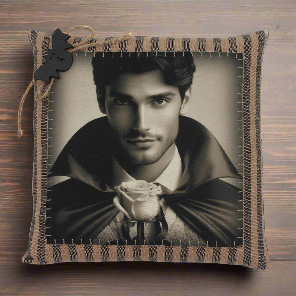 Decorative pillow with a portrait of a  handsome young vampire holding a rose on a white background
