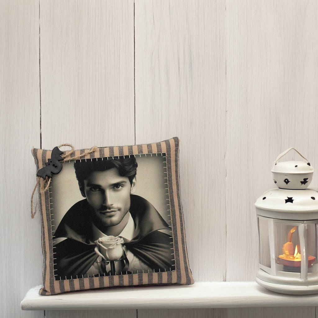 Decorative pillow with a portrait and striped border on a shelf next to a lantern.