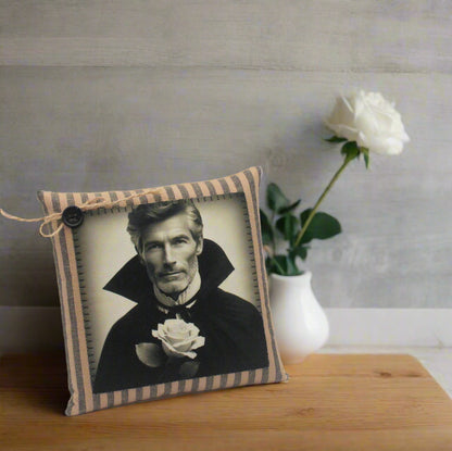 Decorative pillow with a vintage-style portrait of a handsome vampire holding a white rose