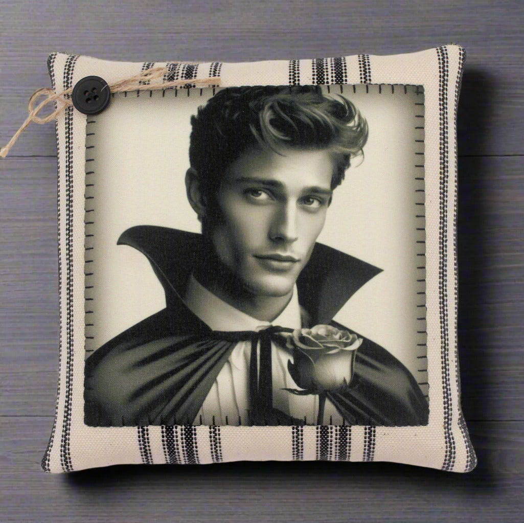 Decorative pillow with a black and white portrait of a handsome young vampire holding a rose on a striped background.