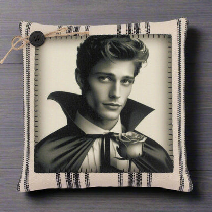 Decorative pillow with a black and white portrait of a handsome young vampire holding a rose on a striped background.